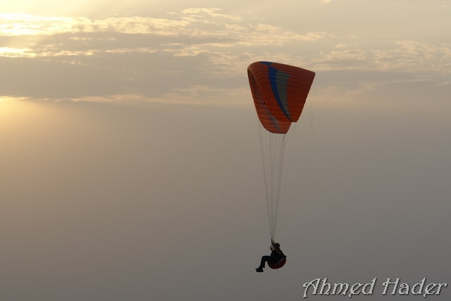 adventure parachuting over mountain near clouds