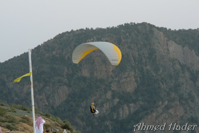 adventure parachuting over mountain near clouds