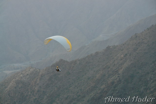 adventure parachuting over mountain near clouds